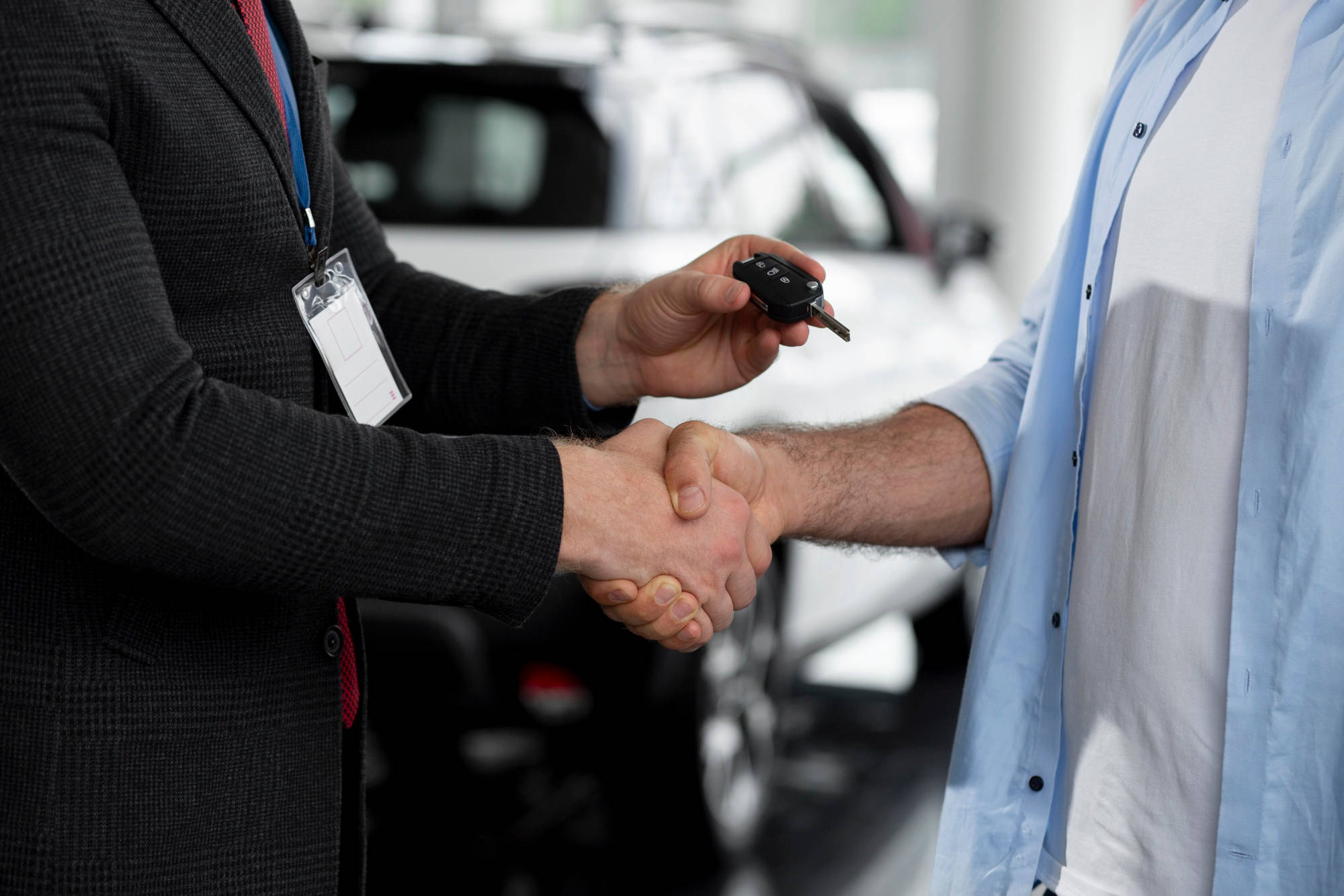close-up-customer-with-business-person-car-dealership
